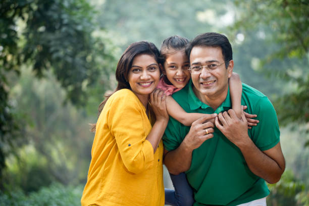 Happy family at park Father carrying daughter on shoulders at park india photos stock pictures, royalty-free photos & images