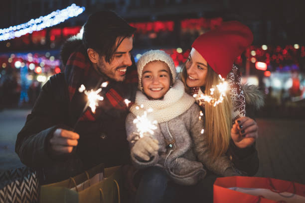 Happy family celebrating Christmas Family with daughter enjoying New Year new years eve girl stock pictures, royalty-free photos & images