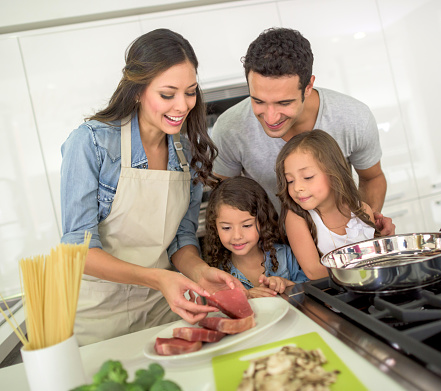 Happy Family Cooking Dinner Together Stock Photo - Download Image Now