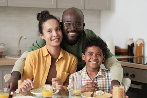 Happy family having breakfast stock photo