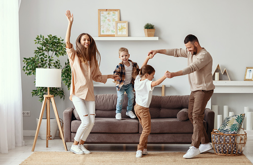 Happy Family Mother Father And Children Dancing At Home Stock Photo -  Download Image Now - iStock