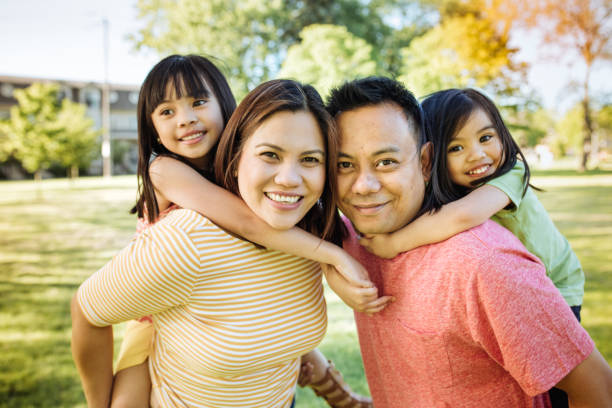 Happy family of four Two parents and two kids filipino ethnicity stock pictures, royalty-free photos & images