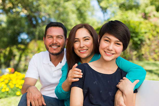 Happy family Portrait of happy family smiling together in a park mexican teenage girls stock pictures, royalty-free photos & images