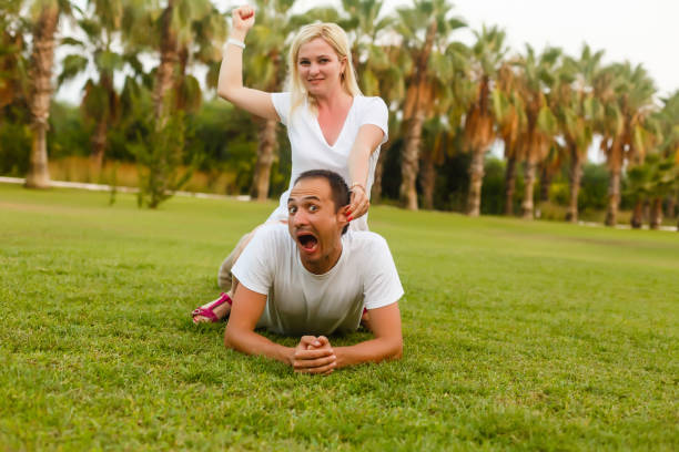 happy family playing and having fun near the palm trees happy family playing and having fun near the palm trees angel 13 stock pictures, royalty-free photos & images