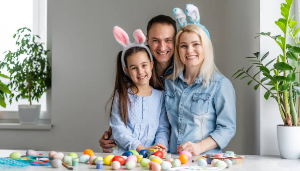 happy family with easter eggs. Happy family preparing for Easter stock photo