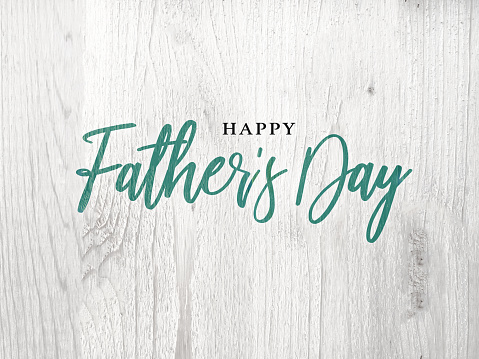 Happy Father's Day Green Calligraphy Script Over White Wood Texture Background