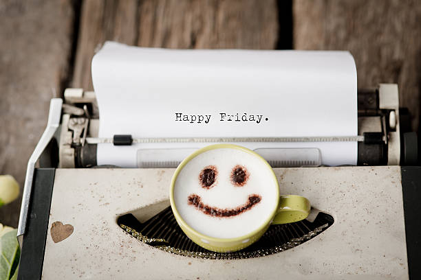 happy friday on typewriter with coffee cup, - happy friday emoticon stockfoto's en -beelden