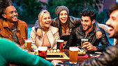 istock Happy friends drinking beer at brewery bar dehor - Friendship lifestyle concept with young milenial people enjoying time together at open air pub - Warm color tones on vivid filter with focus on girls 1300154551