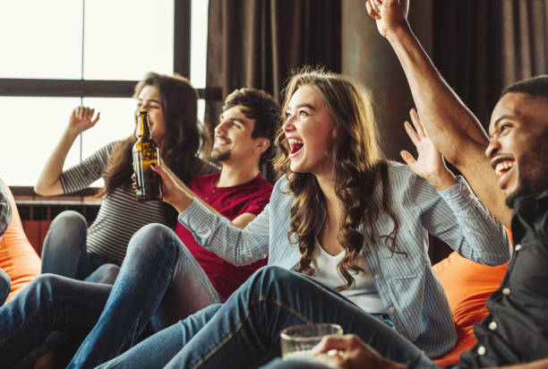 Happy friends football fans Happy friends have a party watching football match. spectator stock pictures, royalty-free photos & images