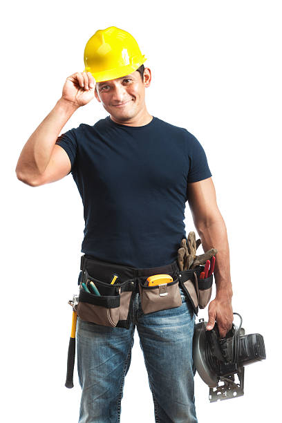 Happy Greeting Hispanic Construction Worker Handyman on White Background Subject: A friendly happy smiling Professional construction contractor worker with hard hat and work tools isolated on a white background. tool belt stock pictures, royalty-free photos & images