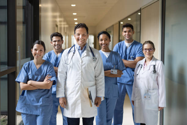 Happy group of healthcare workers smiling at the hospital stock photo