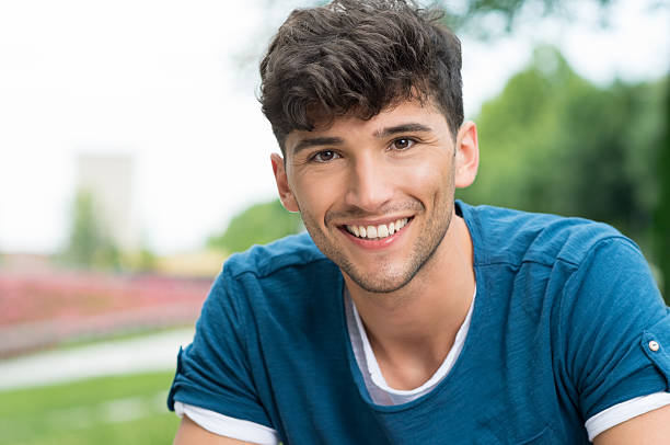 Happy guy Closeup shot of young man looking at camera. Portrait of smiling guy in casual posing outdoor. Smiling teenwith blue tshirt looking at camera at the pak. 18 19 years stock pictures, royalty-free photos & images