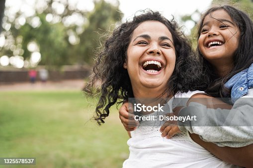 istock Happy indian mother having fun with her daughter outdoor - Family and love concept - Focus on mum face 1325578537
