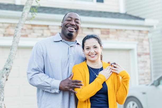 lycklig interracial par utanför hemmet - house with 2 cars bildbanksfoton och bilder
