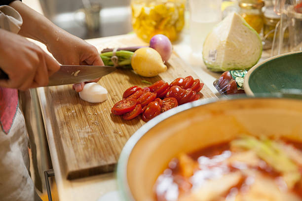 happy japanese mother cooking for family and friends - eten koken stockfoto's en -beelden