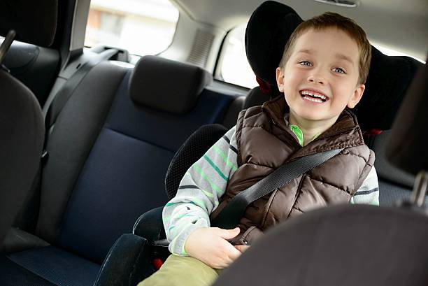 Happy little boy in car safety seat. Happy little boy in car safety seat. Children car safety concept car safety seat stock pictures, royalty-free photos & images
