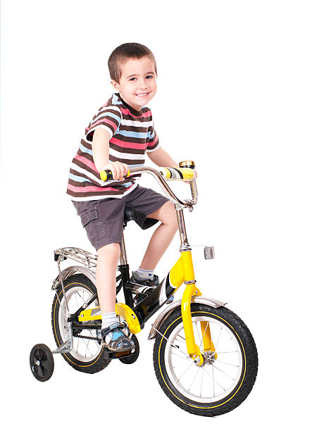 Happy little boy on bike stock photo