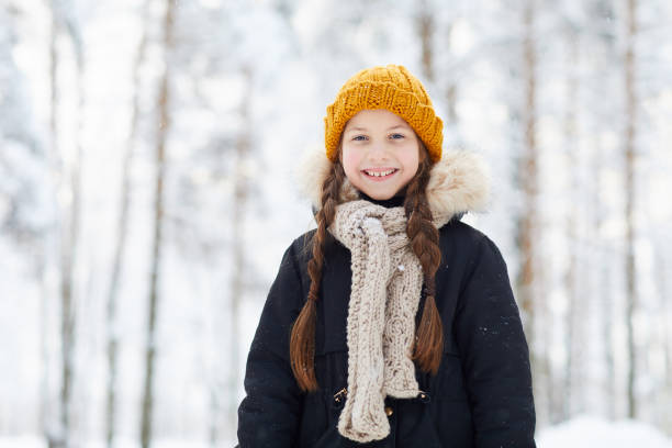 Happy Little Girl in Winter Waist up portrait of happy little girl in winter forest smiling at camera, copy space swedish girl stock pictures, royalty-free photos & images