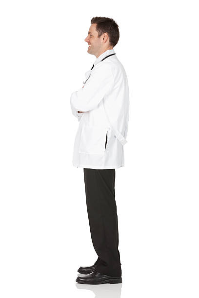 happy-male-doctor-standing-with-his-arms-crossed-picture-id185328429