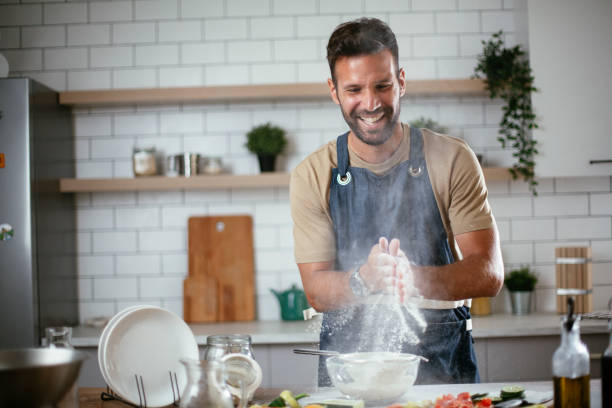 Happy man baking in the kitchen. stock photo