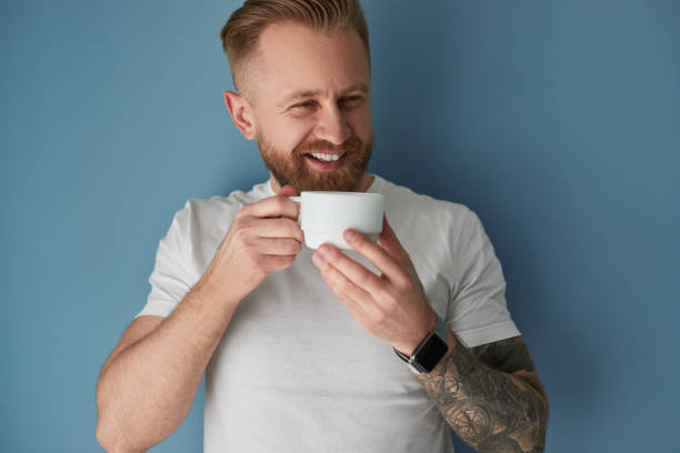 Happy man enjoying cup of coffee stock photo