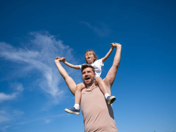 Happy man holding his little daughter stock photo