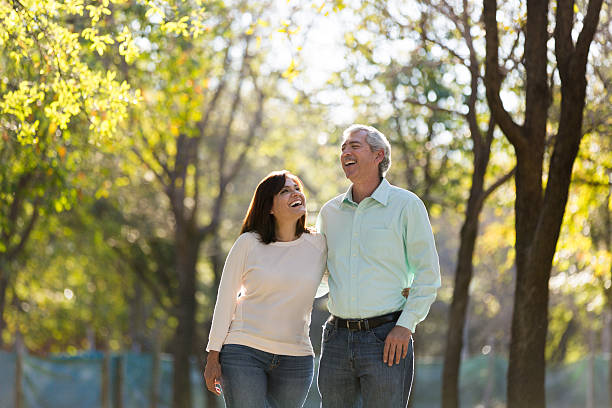 Happy mature couple Smiling happy mature couple in a park 50 59 years stock pictures, royalty-free photos & images