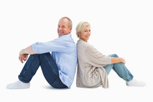 Happy mature couple smiling at camera Happy mature couple smiling at camera on white background 50 59 years stock pictures, royalty-free photos & images