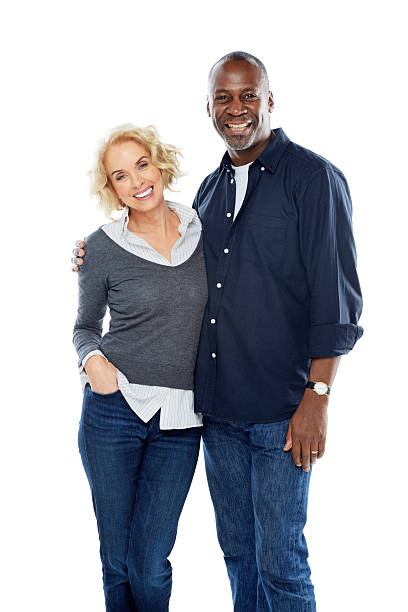 Happy mature interracial couple standing together on white stock photo