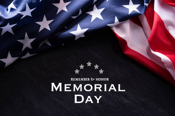 Happy Memorial Day. American flags with the text REMEMBER & HONOR against a blackboard background. May 25. stock photo