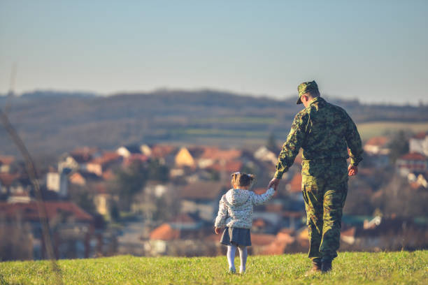 Happy military father meeting with daughter after mission Little girl with her hero, Returning from the army military uniform stock pictures, royalty-free photos & images
