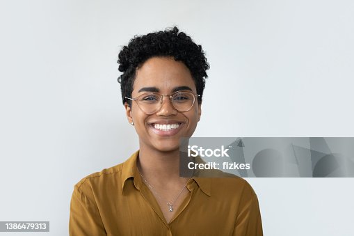 istock Happy millennial Afro American business woman posing isolated on white 1386479313