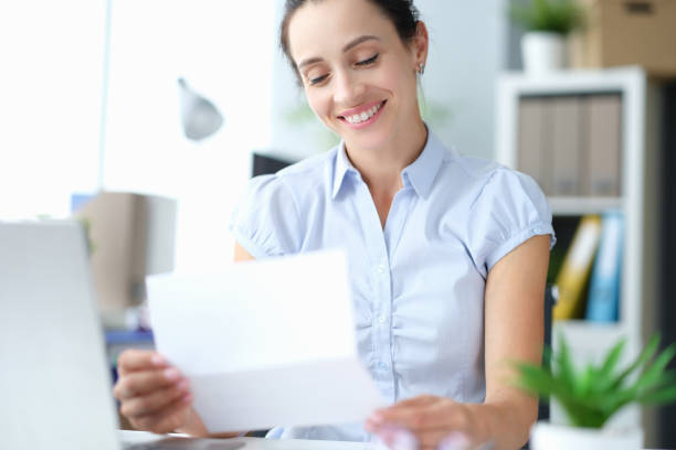 Happy millennial girl site feel excited reading good news in postal paperwork letter stock photo