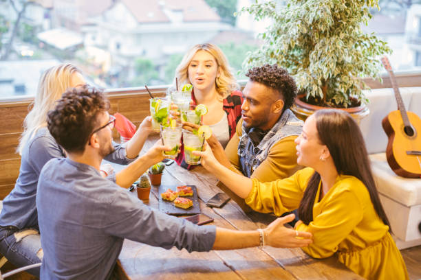 Happy millennials friends toasting and celebrating together stock photo