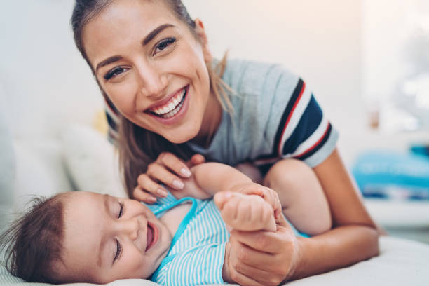 Happy mother and baby boy Mother playing with her baby tickling beautiful women pictures stock pictures, royalty-free photos & images