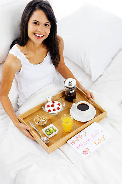 Happy mothers day breakfast in bed mum with card and tray of...