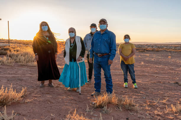 Happy Native American, Navajo Family Wearing Masks For Protection From Covid19, Monument Valley Tribal Park, Utah Near Sunset Happy Native American, Navajo Family Wearing Masks For Covid19 Protection,  Monument Valley Tribal Park, Utah Near Sunset navajo nation covid stock pictures, royalty-free photos & images