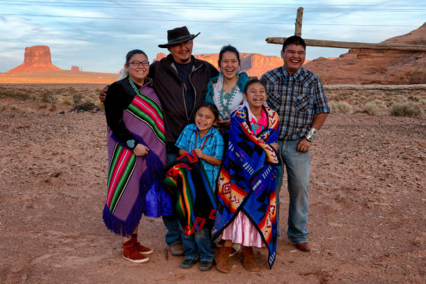 Happy Navajo Family Happy young family of Navajo people posing and laughing together on their land in Monument Valley Arizona navajo culture stock pictures, royalty-free photos & images