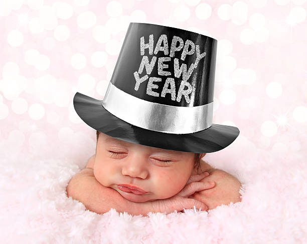 Happy New Year baby Newborn baby girl wearing a Happy New Year hat. new years eve girl stock pictures, royalty-free photos & images
