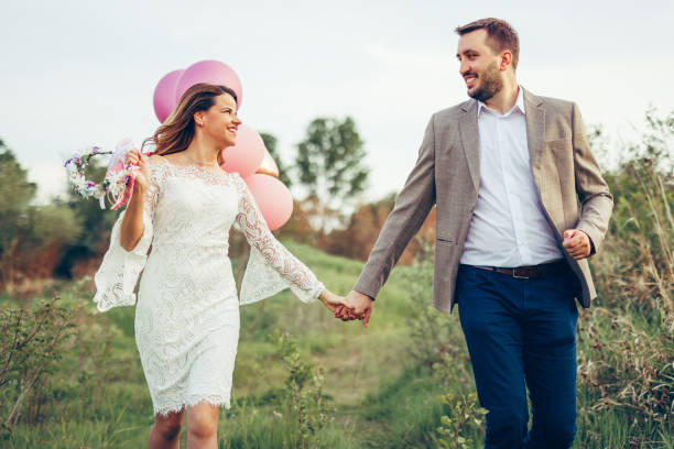 Happy newlyweds walking and looking each other stock photo