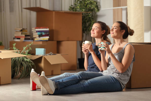 Happy roommates moving home resting breathing fresh air Happy roommates moving home resting breathing fresh air roommate stock pictures, royalty-free photos & images