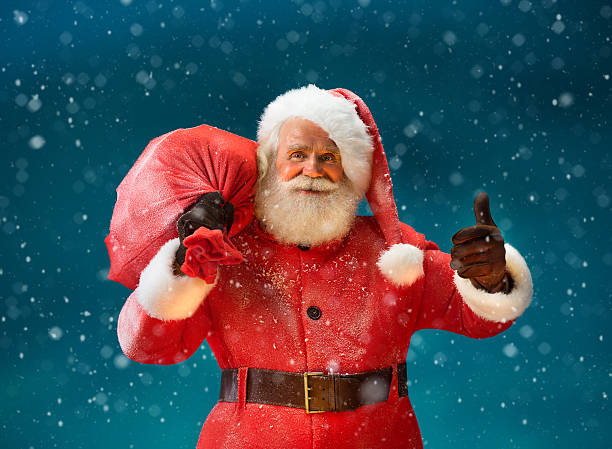 happy-santa-claus-gesturing-thumb-up-with-big-bag-picture-id613133608