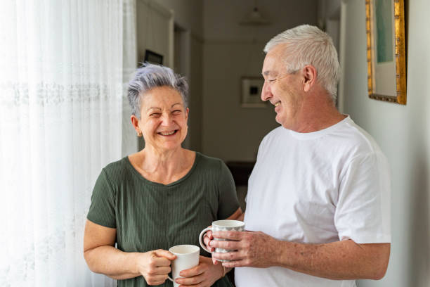 Happy Senior Couple Enjoying a Cup of Tea at Home stock photo