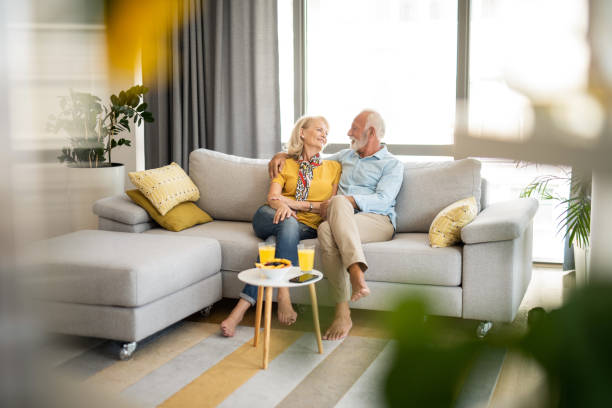 Happy senior couple relaxing in the living room. stock photo