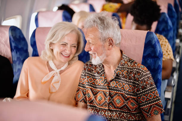 Happy senior couple smiling during flight stock photo