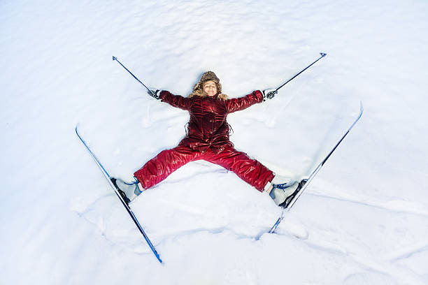 Happy skier laying as a star on the snow stock photo