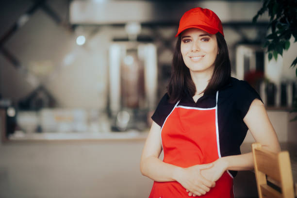 Happy Smiling Fast-Food Worker Standing in a Restaurant stock photo