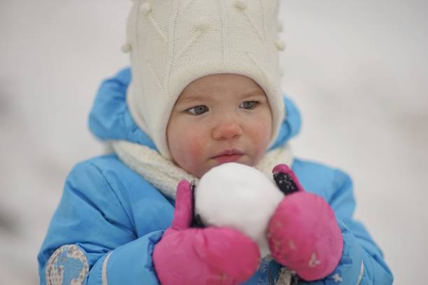Happy snow baby girl stock photo