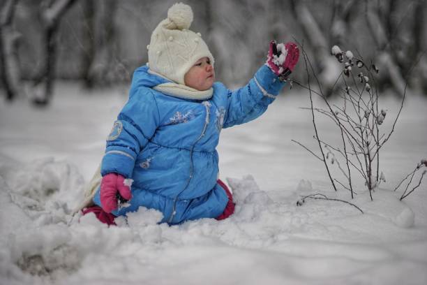Happy snow baby girl stock photo