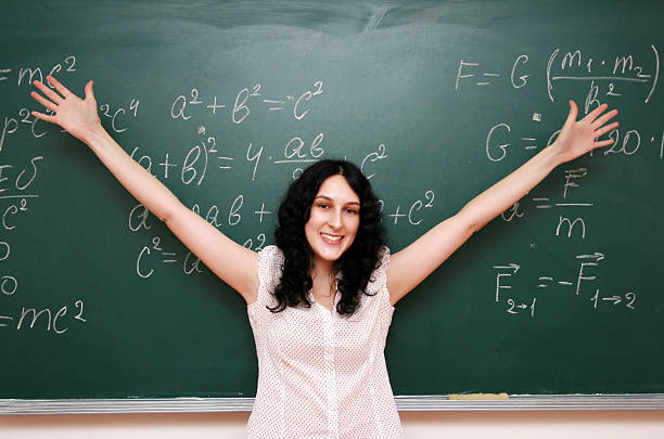 Happy student near the blackboard stock photo